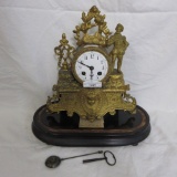 French ormolu clock w/ embossed cherub face and man standing on rock. 13 x