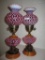 Fenton pair of cranberry opal Daisy Optic dresser lamps. 18