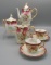 Early Years hand painted teaset w/ 2 cup & saucers. red border w/ gold flor