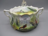 RS Prussia medallion mold cracker jar w/ Pheasant decor in woods.