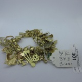 14K gold charm bracelet. 85 grams