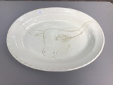 Oval porcelain serving piece with longhorn decoration