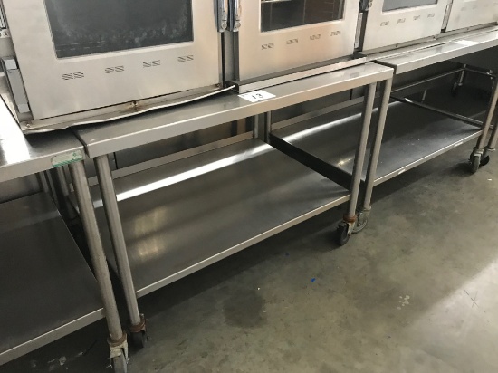 4' Stainless table with backsplash and shelf