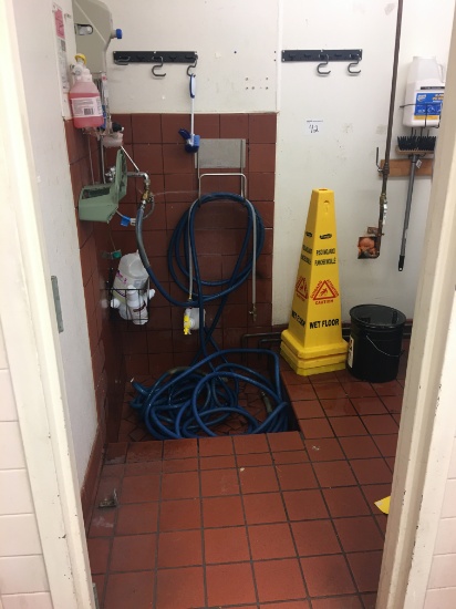 Water hose and wet floor sign
