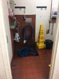 Water hose and wet floor sign