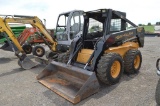 NH LX885 Turbo skid loader w/ 1231hrs, hyd quick att, aux hyd, 60'' material bucket, 12-16.5 rubber