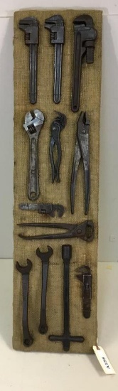 Various vintage and antique wrenches on display board