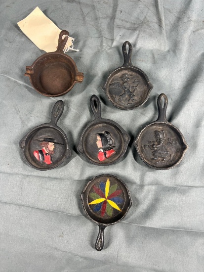 5- Scenic Cast Iron Ashtrays, and one unmarked ashtray