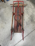 Vintage metal runner sled and pair of ice tongs