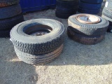 (2) 10.00-20 tires on rims, (1) 12r22.5 tire on rim, (1) 12r22.5 tire