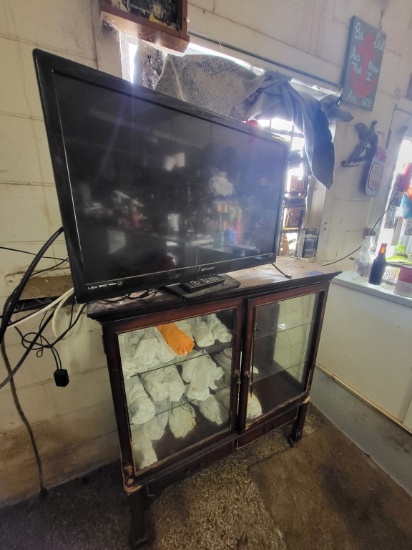 Glass 2 Door Cabinet W/ 18 Tshirts