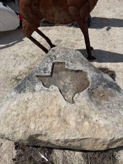 Limestone landscape rock with Texas carving.
