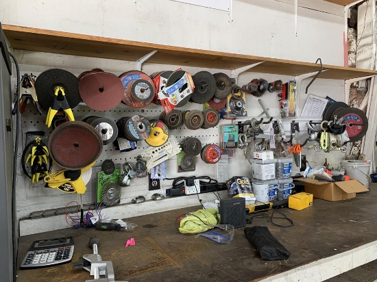 Contents of wall, top of work bench - grinding discs, sanding discs, safety glasses, hardware, tape