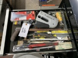 Contents of drawer - staple gun, staples, hacksaw