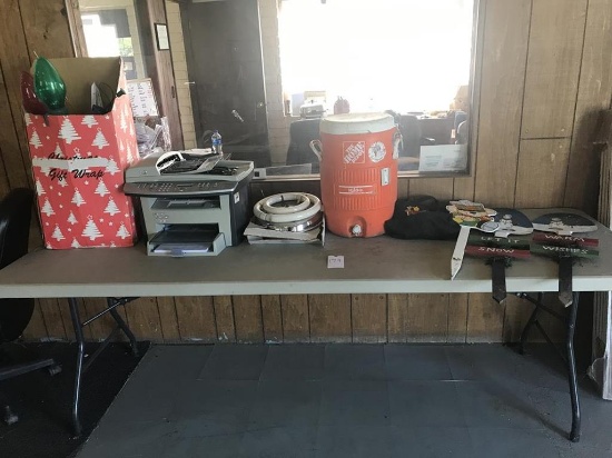 table of miscellaneous items (water cooler, printer, Christmas decorations, light fixture)