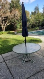 TWO OUTDOOR GLASS TABLES