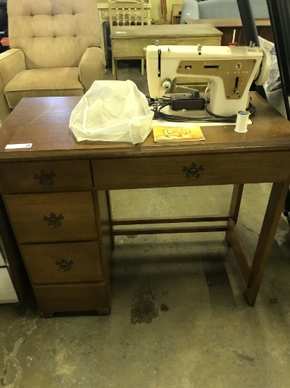 Singer model 237 Sewing Machine on storage cabinet, comes with cover and manual (lot 10)