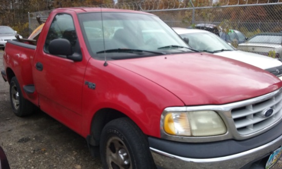 1999 red Ford F150 pick up truck