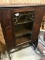 Solid Wood, Likely antique curio cabinet.  Appears to be original glass, with fixed shelves, 57 inch