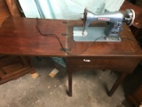 Vintage White Brand Sewing Machine, with table.  Folds away for storage.  This unit powers on, but w