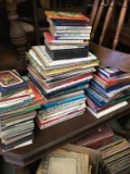 Several stacks of books, many are Teddy Bear Themed, or religious