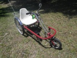 Side-entry, sit-down tricycle with white plastic seat and metal basket.