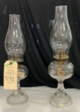 TWO SMALL CLEAR KEROSENE LAMPS WITH DESIGN ON BASE (CHIP ON BASE)