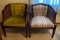 Two wooden and wicker barrel chairs with upholstered seat and back