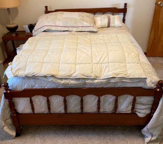 Double sized bed with sheets and comforter