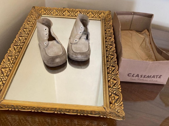 Vintage baby shoes and a mirrored tray