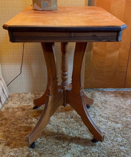Antique wooden table on casters