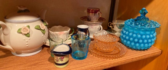 Cups and saucers, tea pot and miscellaneous decorated glassware, including pink depression