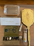 Antique hand mirror, brush, garter and sewing kit
