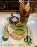 Vintage cutting tray, cast iron hot plate, ladle, and wooden spoons