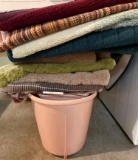 Pink vintage trashcan, bucket and several rugs