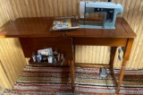 Sears sewing machine in wooden cabinet includes foot