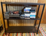 Metal shelf with RCA video player and tapes