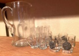 Clear glass pitcher and shot glasses