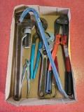 Bolt cutters, adjustable wrenches, pipe wrench, nail bar, and other tools