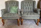 Two olive green wing back chairs