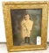 Antique photograph of a small boy in a gold frame