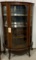 Antique curved glass curio cabinet on casters