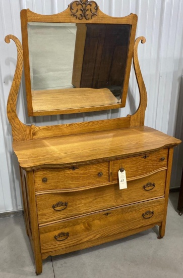 Antique four-door dresser on casters with mirror