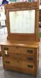 Antique three drawer dresser on casters with mirror