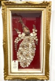 Antique artwork of a peacock made with seashells