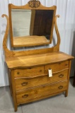 Antique four-door dresser on casters with mirror