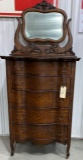 Antique curved front five drawer dresser with mirror and on wheels