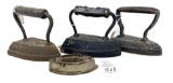 Three antique cast iron irons, one base