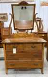 Antique four drawer dresser with mirror and on wheels