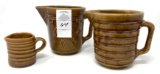 Three brown crock pitchers